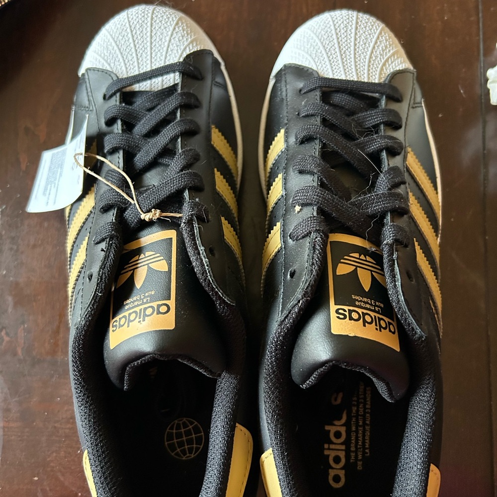 Adidas Superstar Black with Gold Stripes (men’s 9.5)